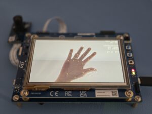 STM32N6570DK showing the hand pose detection demo in the display, one hand is being detected