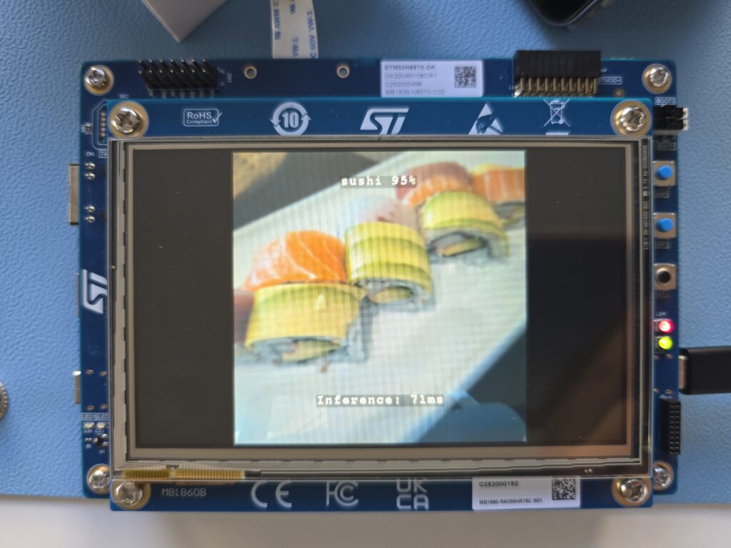 The STM32N6570-DK showing the detection of sushi on screen